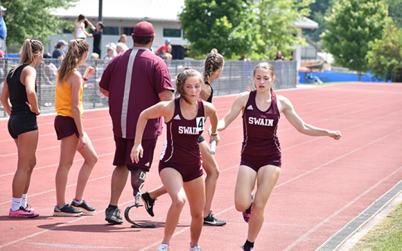 Lady Devil Emily Ulaner hands off to Amaya Hicks in the 4x400 relay at regionals.