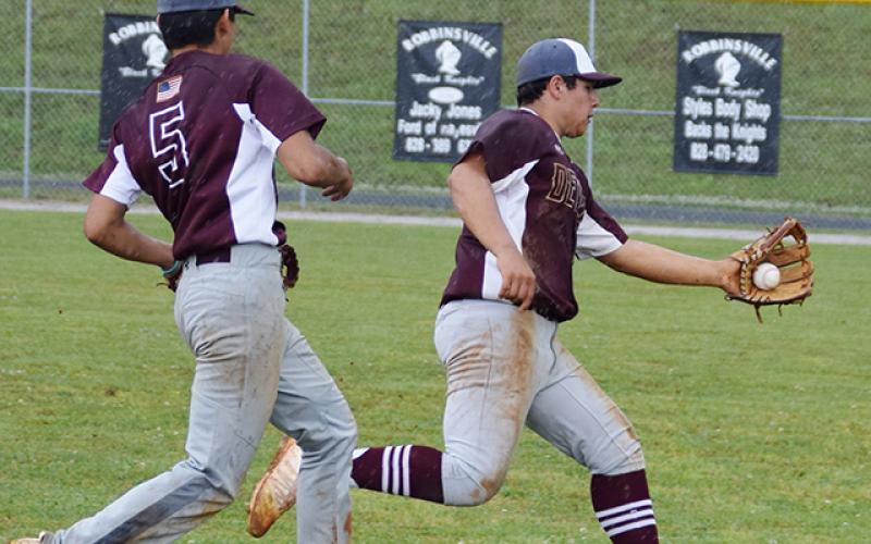 From left are Maroon Devils Damian Lossiah (5) and Carson Taylor (22), who catches the ball.