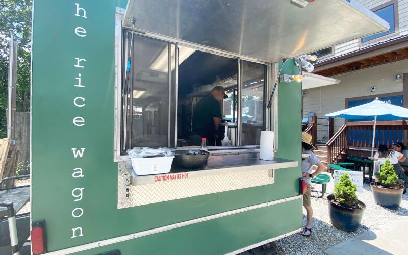 Jeremiah Chatham, owner of The Rice Wagon, is pictured inside his establishment helping a customer.