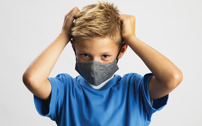 Kid putting on mask