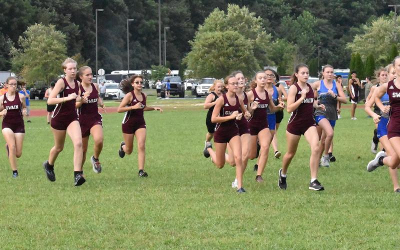 Lady Maroon Devils take off at the starting line at the recent meet held at Cherokee.