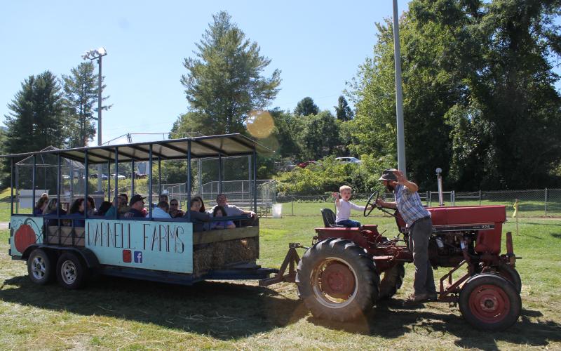 Nate Darnell lets the kids “take the wheel” with the tractor hay rides.