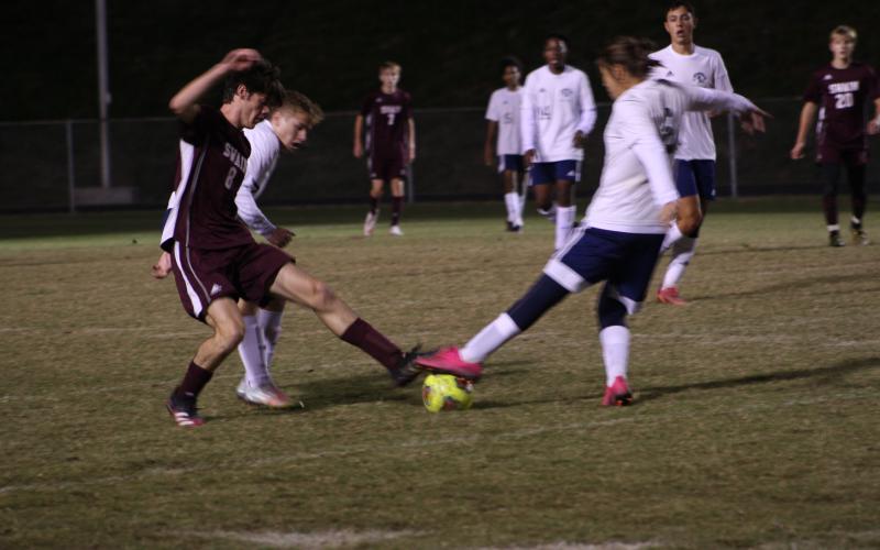Maroon Devil defender Levi Trantham battles it out for the ball against two Stallion players.