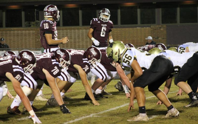 Maroon Devils Gabe Lillard and Donnavin Groenewold before the snap, while linemen hold position in the home win against the Yellow Jackets.