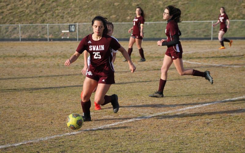 Senior Avery Maples steals the ball from a Yellowjacket at Monday night’s game. She had four goals against Murphy in last Thursday’s game.