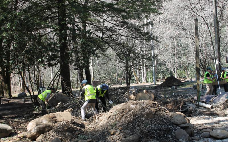 Lead Ranger Adam Monroe and volunteers move debris out of a freshly excavated site at Smokemont Campground during a recent Smokies Service Day.