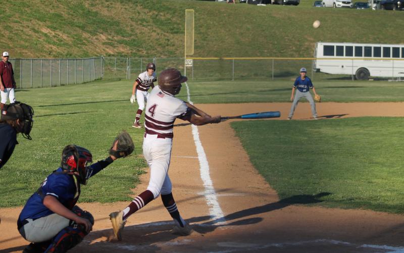 Reese Winchester is up to bat, as Cooper Hyatt stares down home plate from third base.