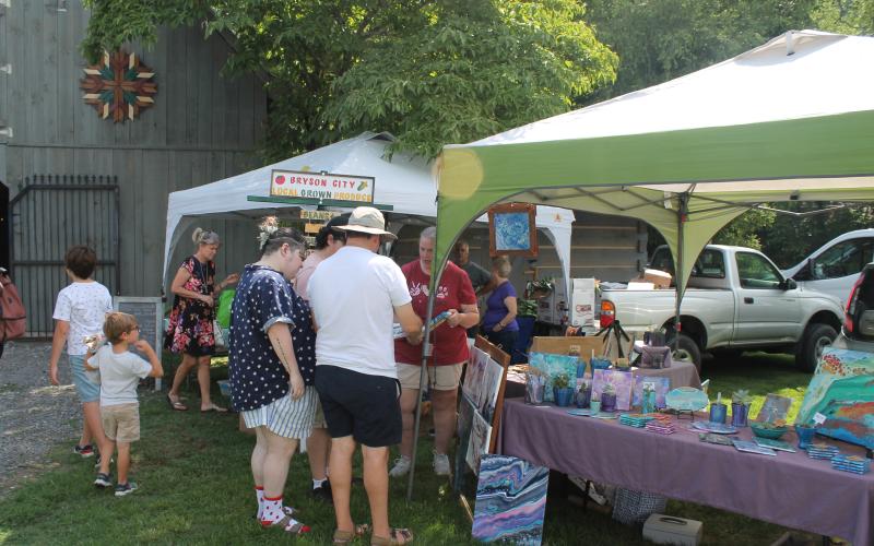 People shop from local crafters at the market