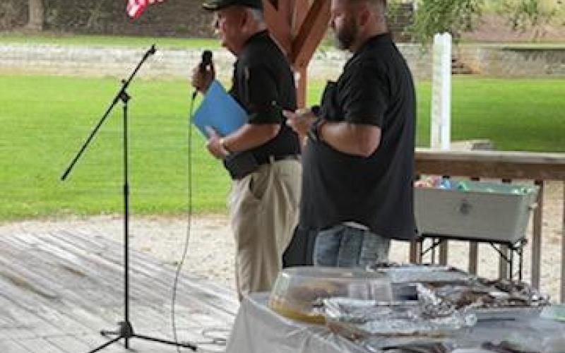 Swain County Sheriff Curtis Cochran is at the mic and Commissioner Kevin Seagle is behind him.