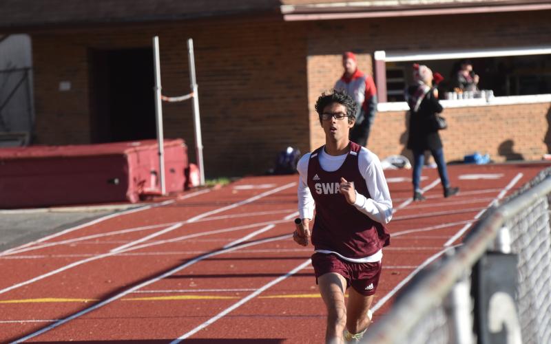 Photo by Joanna McMahan/Swain Schools Maroon Devil Abhi Patel runs in the boys relay at the Swain County Polar meet last week.