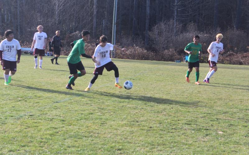 Maroon Devil Kale Stephenson fends off a Bobcat player.