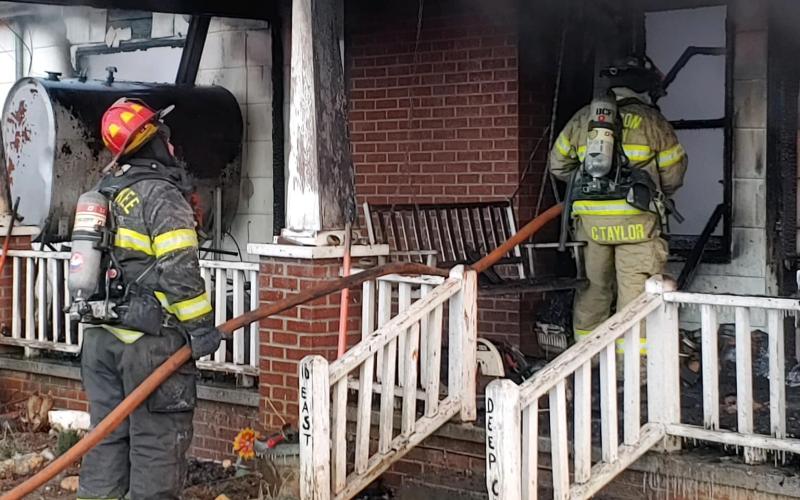 Volunteer firefighters work on a house fire in Deep Creek on Christmas Eve.