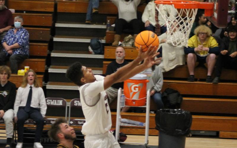 Maroon Devil Josiah Glaspie goes up for a basket with a Bulldog on his heels during the home game on Tuesday.
