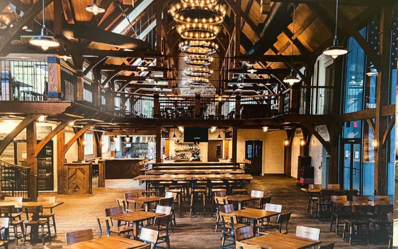 This photo provides an example of what the inside of the finished dining area will look like. Notice the exposed timber frame and the large windows that will face the river.