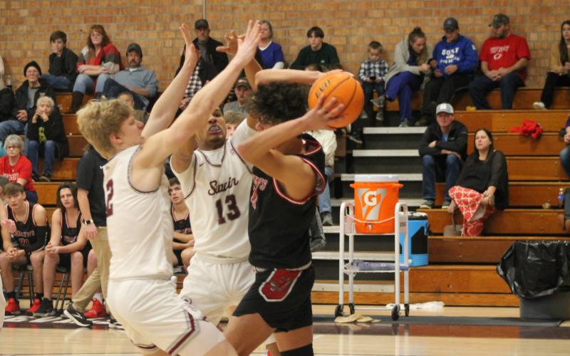 Ray Bradley (left) and Josiah Glaspie of Swain County High's varsity basketball team try and intercept the opposition at the Jan. 24 home game.Credit: Larry Griffin/SMT