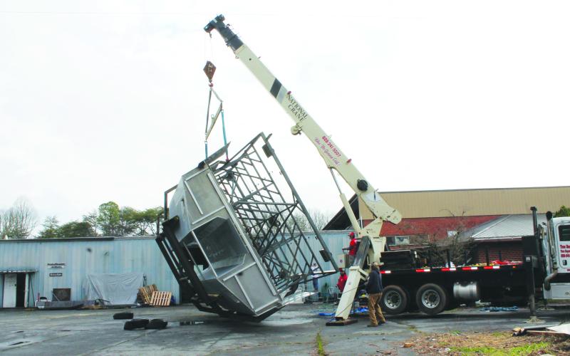 At Smoky Mountain Boatworks in Bryson City on Thursday, March 23, a Catamaran boat was flipped over by a crane, with inspectors intending to come by this week to make sure it’s ready for sailing in Albemarle Sound for passenger trips.