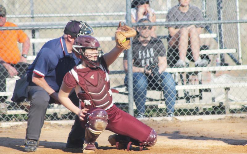 Carley Teesateskie catches a pitch as the Lady Devils played the Rosman Tigers on Tuesday, Feb. 28.