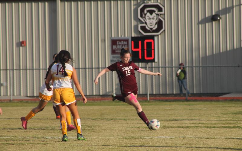 Lady Devil Karena Cline shoots the ball down field at the home game March 23.