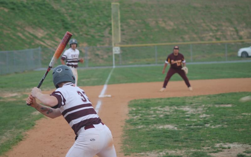 Carter Hayes is at bat at the baseball game April 5 as Gabe Lillard lingers on third, trying to come home.
