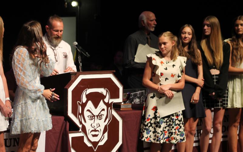 Amaya Hicks (from left), Annie Lewis, Angelina Lomeli, Amelia Rogers and Alden Thomas were among those who received awards for girls’ track from Coach Keith Payne at the Athletic Awards ceremony.