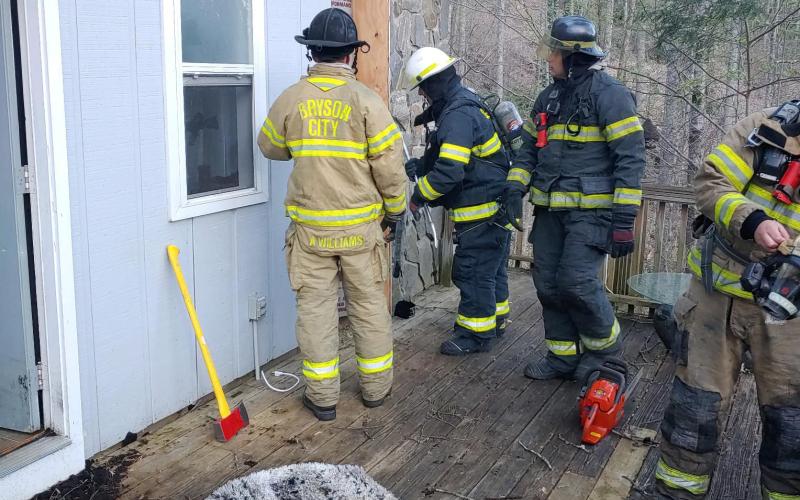 Commissioners are considering the need for more firefighters in the county. Pictured, Bryson City and other local departments responded to a house fire earlier their year.