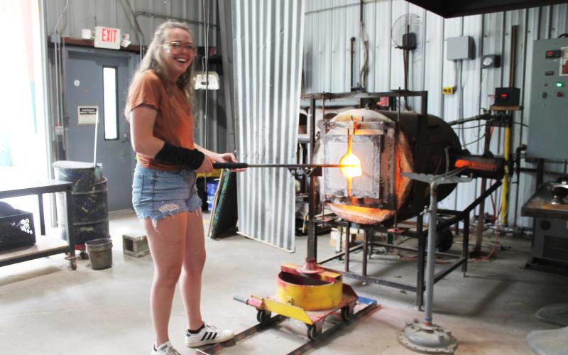Glassblower apprentice Rachel Raming at the Green Energy Park works with one of the ultra-hot furnaces – which are powered by the nearby landfill.