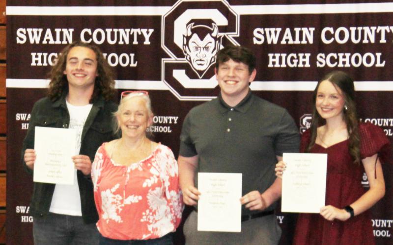 Julia Hunt presented the Julia Hunt Endowment Scholarship to Canon Helpman, Benjamin Payne and Kathryn Roland. Graduating seniors receive this award for their service to the local community.
