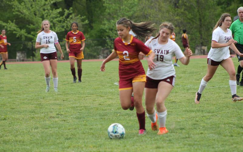 Rose Carson clashes with a Cherokee Braves player at Monday’s game.