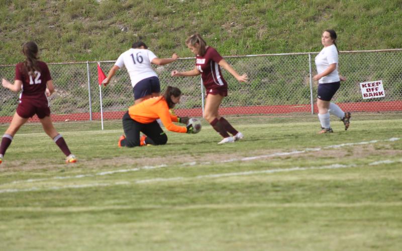 The Tri-County goalie gets the ball ahead of offense moves from the Lady Devils.