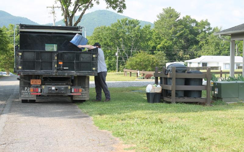 Bryson City town worker Logan McCall runs the residential recycling pick-up on Wednesday morning. He's pictured here collecting recyclables from homes on Hospital Hill.