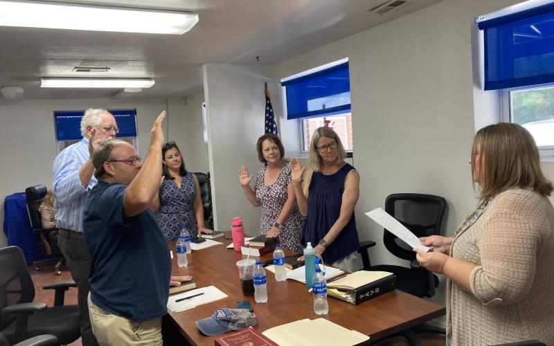 Swain County Clerk of Courts Misti Jones (right) led each of the new members in the swearing-in ceremony, held at the BOE office. The board includes from left Jeramy Shuler, John Herrin, Hannah Smith (chairwoman), Frances “Nannett” Powell and Mary K Buranosky.