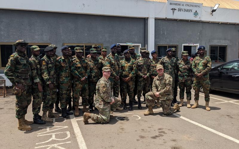 Ghana Armed Forces Brig. Gen. Nii Adjah Obodai, commander, 37th Military Hospital in Accra, Ghana, presents U.S. Air Force Tech. Sgt. Daniel Fisher, Defense Medical Readiness Institute’s Academic Support Branch noncommissioned-officer-in-charge, with a gift of appreciation for establishing a tactical combat casualty care training site in March 2022. (Courtesy photo)