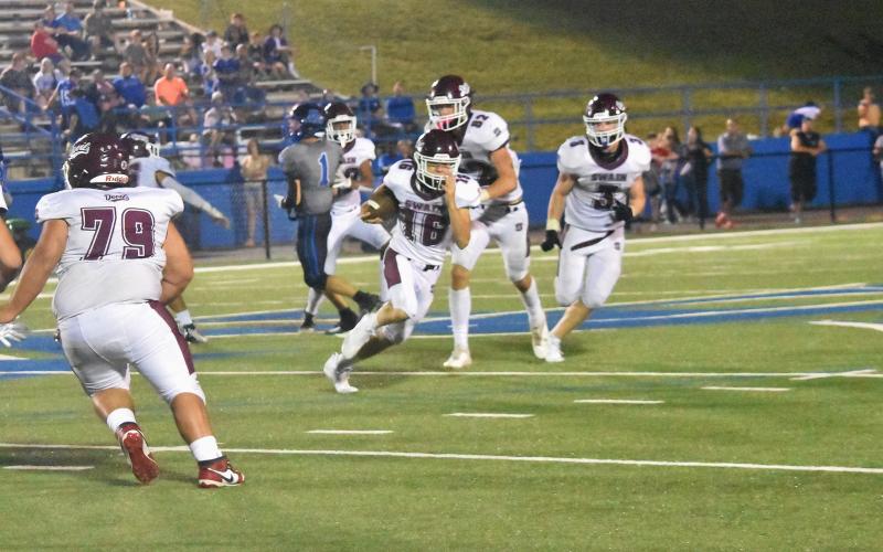 Maroon Devils Leland LeQuire (from left), Andrew Cody and Josh Collins make plays and try to keep the ball in the team’s hands during the Aug. 25 game against Smoky Mountain. The Devils won the game 14-10.