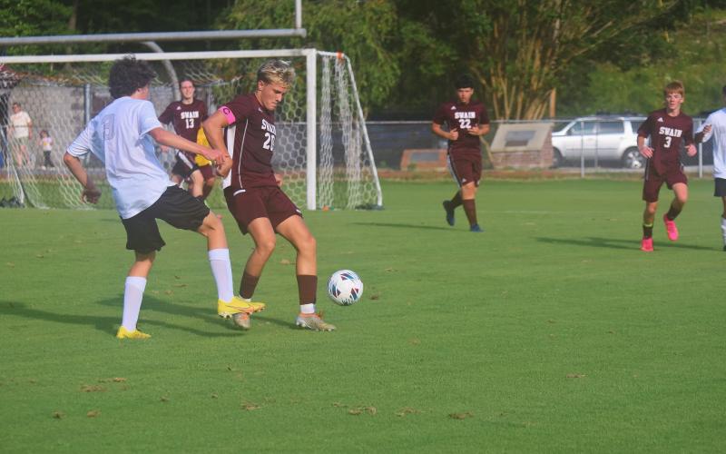 Owen Craig fends off an opponent from North Buncombe at Monday’s game.