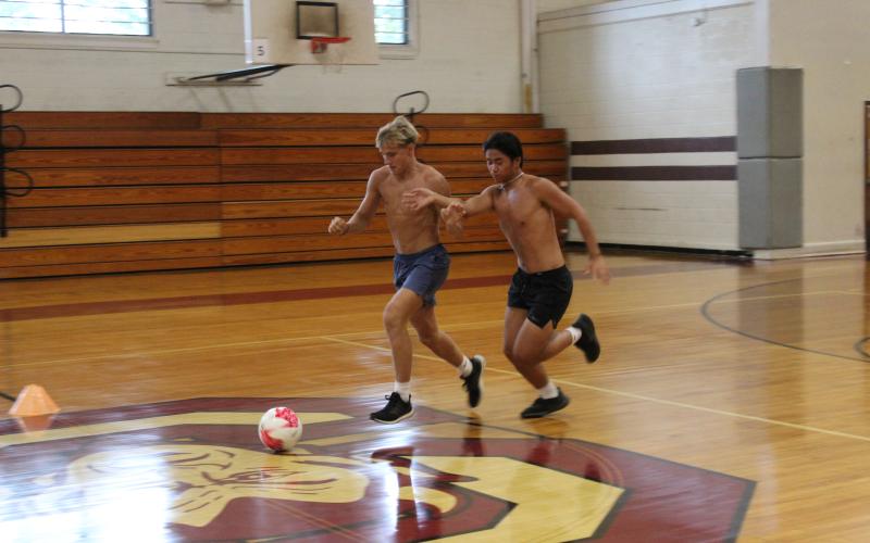 Maroon Devils Owen Craig (left) and Kyle Nguyen vie for the ball during practice.
