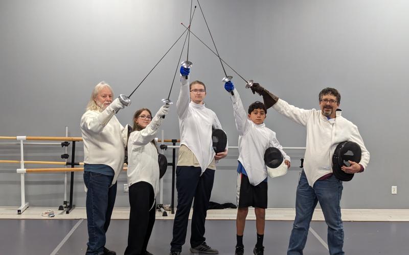 Smoky Mountain Fencing Academy has classes on Wednesday nights from 5-7:30 p.m. at Pirouettes studio. Pictured are the instructors Jim Paintiff (far left) and Joe Holt (far right) with students.