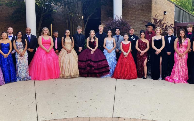 Homecoming court is pictured with their escorts on homecoming