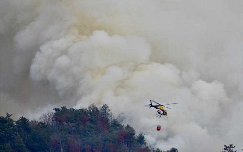 A heavy-lift helicopter prepares to drop water from a bucket on a hot spot in the Collett Ridge Fire east of Pisgah Road in Cherokee County near Andrews on Thursday.