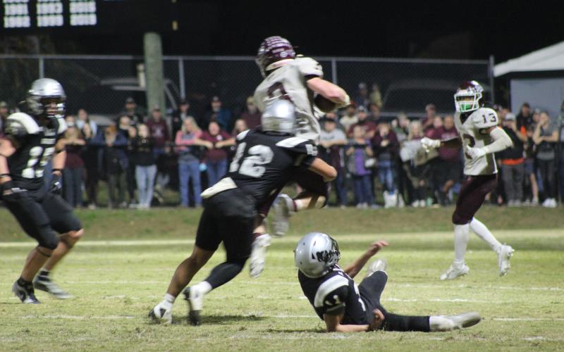Josh Collins (from left) and Josiah Glaspie get in the fray at the football game in Robbinsville on Friday, Oct. 27, in which the Devils lost 14-8 and broke their winning streak for the season after several games.