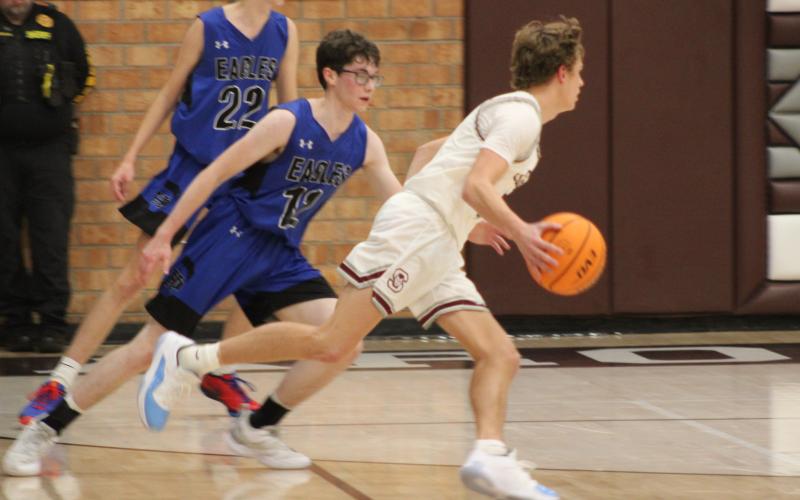 Maroon Devil Reese Winchester takes hold of the ball and gets ready to shoot at Tuesday’s game against the Eagles.