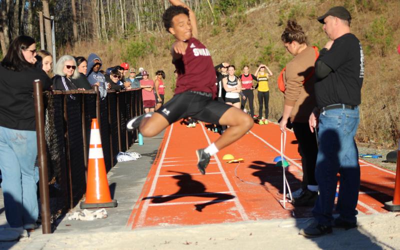 Sophomore Zeke Glaspie performs the high jump at the Dec. 7 track meet. He got a mark of 18-11, coming in first place at the meet.