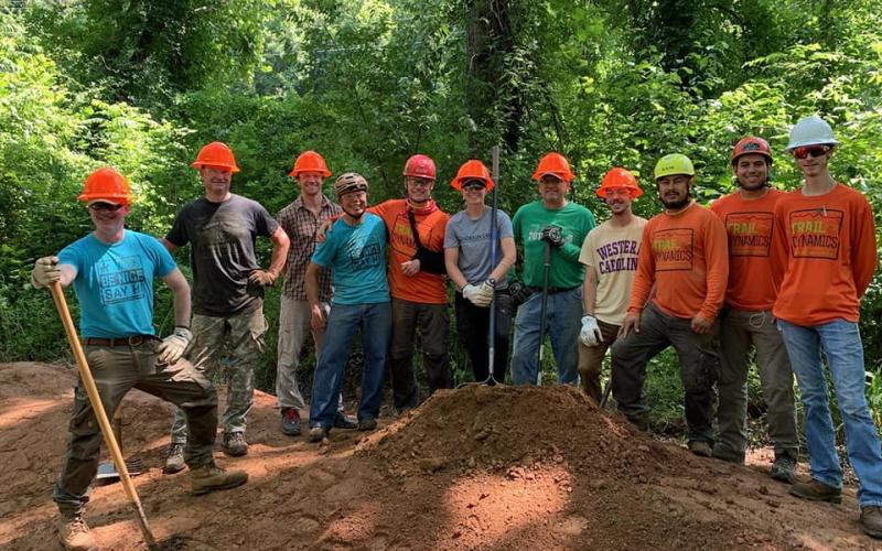 Several members of Nantahala Area SORBA pose with Trail Dynamics, which works on building new mountain bike trails.