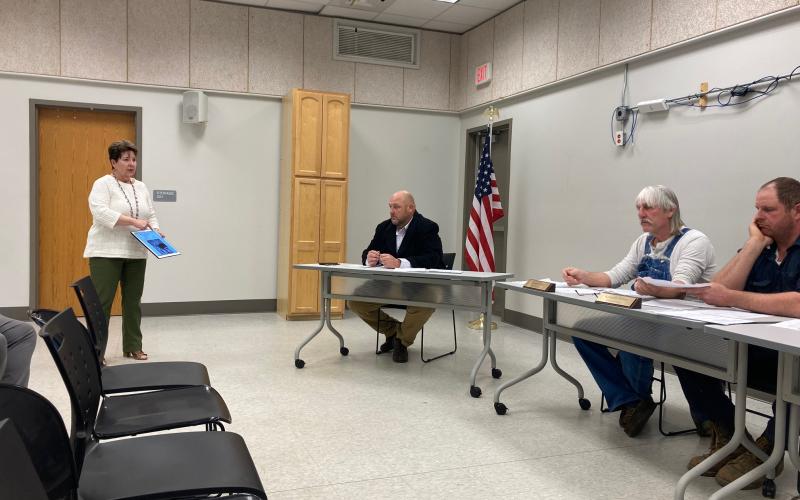 From left, Amy Vasquez speaks to commissioners during public comment about the need for animal control. County manager Kevin King and commissioners David Loftis and Kenneth Parton listen.