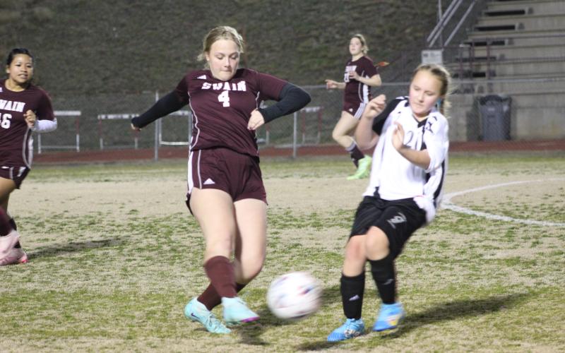 Senior Anna Gray goes in for a kick at the scrimmage Thursday evening, in which the Lady Devils practiced alongside Mountain Area Christian Academy.