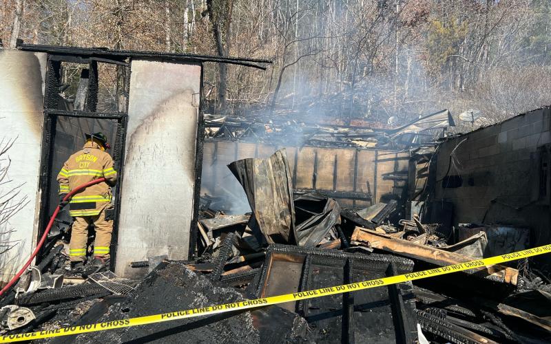 Firefighters continue to work at a structure fire on Hughes Branch Road. The building was a standalone garage with an apartment above. No one was injured in the fire that started Sunday afternoon.