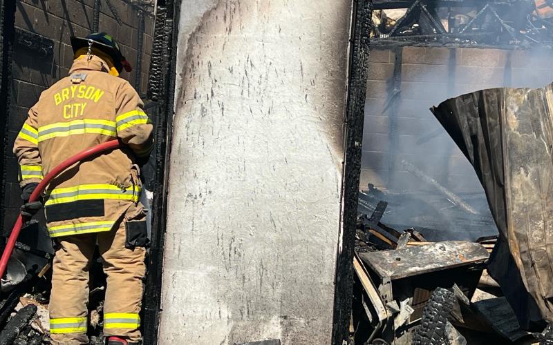 A Bryson City Fire Department firefighter works on a structure fire last week. Fire Chief Charles Bryson wants to staff the department to have someone at the station 24/7.