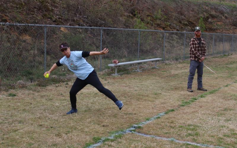 Sally Hall competes in the softball throw competition.