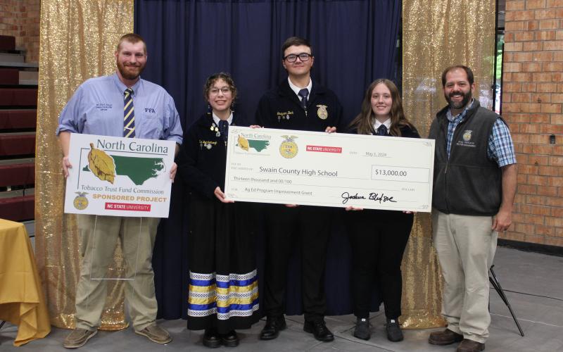 Jessica Webb/SMT Swain County High School’s FFA was awarded a check of $13,000 from the North Carolina Tobacco Trust Fund presented by Western Region Agriculture Education Coordinator Andy VonCanon during the FFA’s banquet held at the high school gym this past Friday. Pictured from left is FFA advisor Toby Sorrell, 23-24 president Eva Bottchenbaugh, secretary Greyson Beck and parliamentarian Lily Craig with Mr. VonCanon.