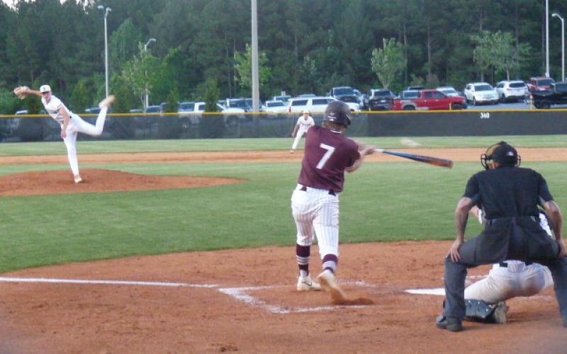 Maroon Devil Lawson Woodard connects in the first inning in the playoff game against Draughn.
