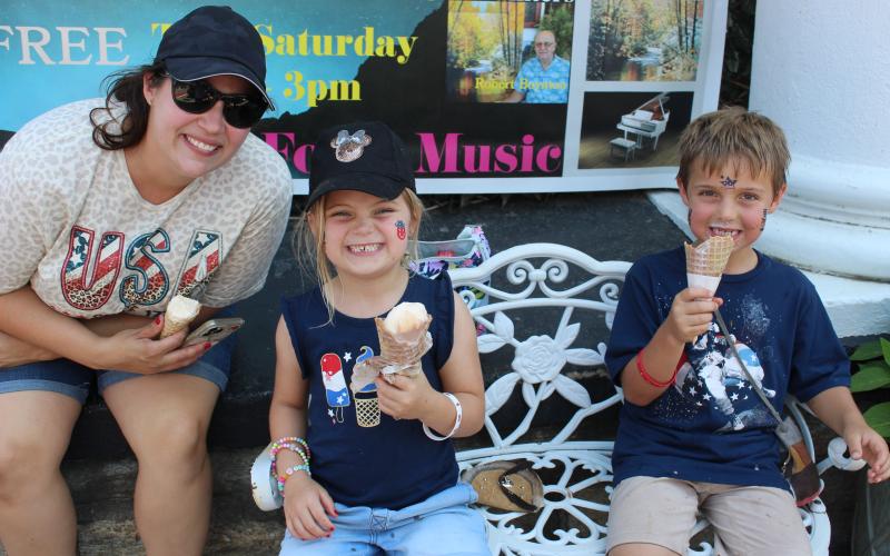 From left, Amy, Dell and Henry Hawk, of Lexington, S.C., enjoy a cooling treat of soft serve while decked out in their Independence Day best at Freedom Fest in downtown Bryson City. See more photos on 7A.